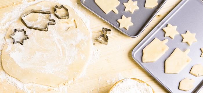 Home made Hanukkah cookies being cut out of pastry