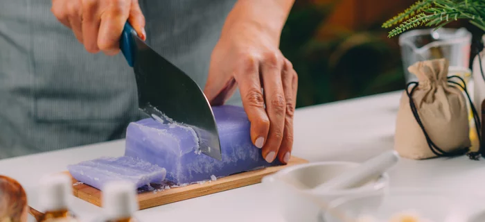 A block of homemade soap being cut into slices