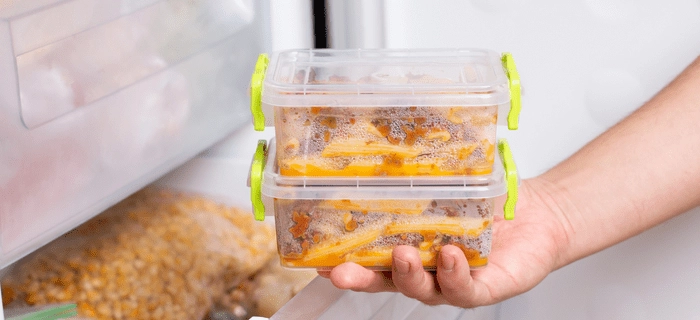 Portions of food being put into a freezer
