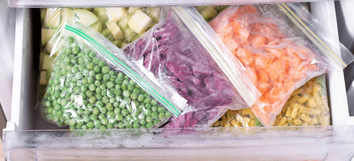 Bags of vegetables in a freezer