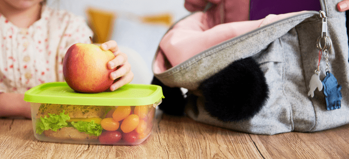 A school bag and lunch box in a table