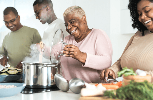 A family laughing and cooking together