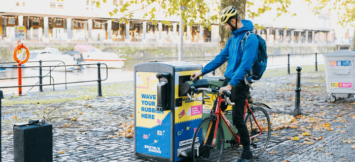 A man stops on his bike to use a Bristol's binning litter bin
