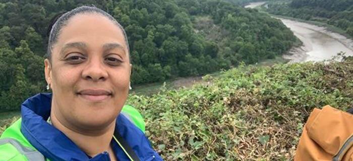 Jayne standing next to a river in Bristol during a litter pick