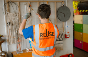 A volunteer at the Reuse Shop is replenishing stock