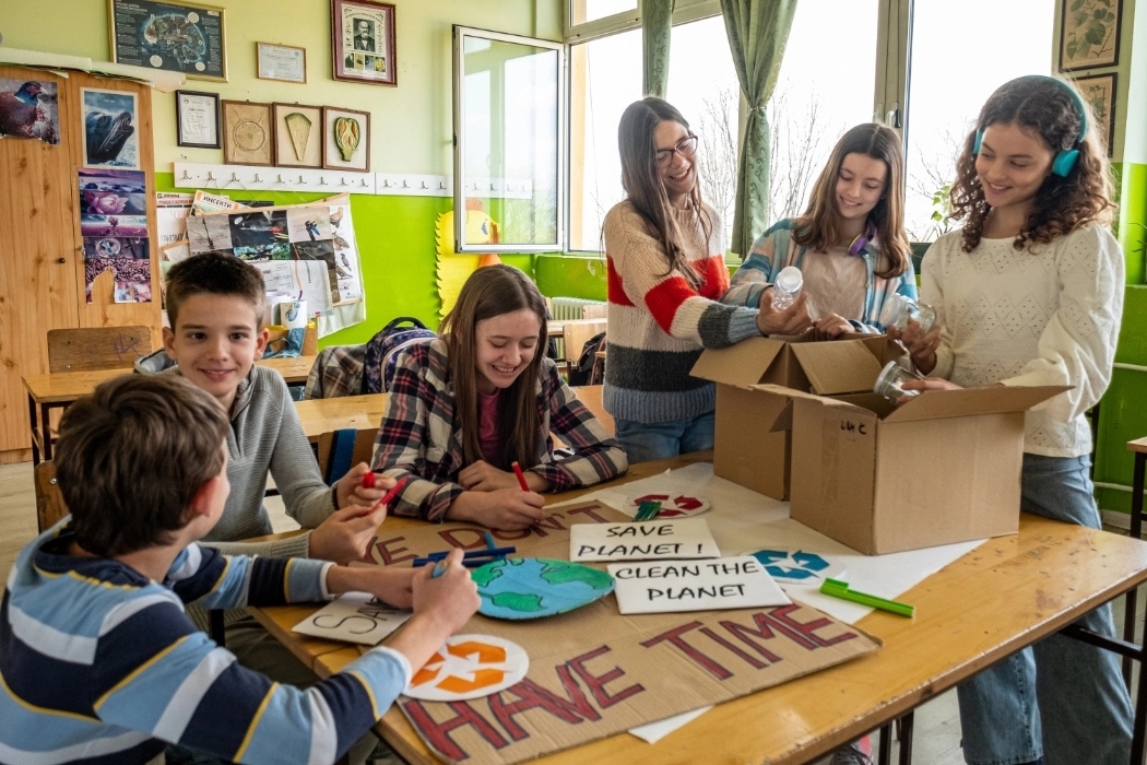 Children participating in making recycling posters