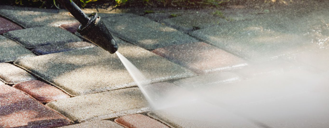 A pressure washing cleaning a patio