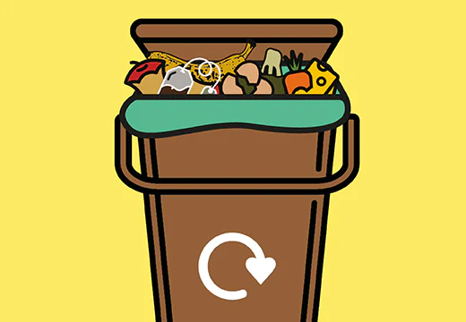 a brown food waste recycling bin with food waste like tea bags, apple cores and chicken bones inside