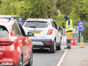 A Bristol Waste team member checks in visitors to the recycling centre