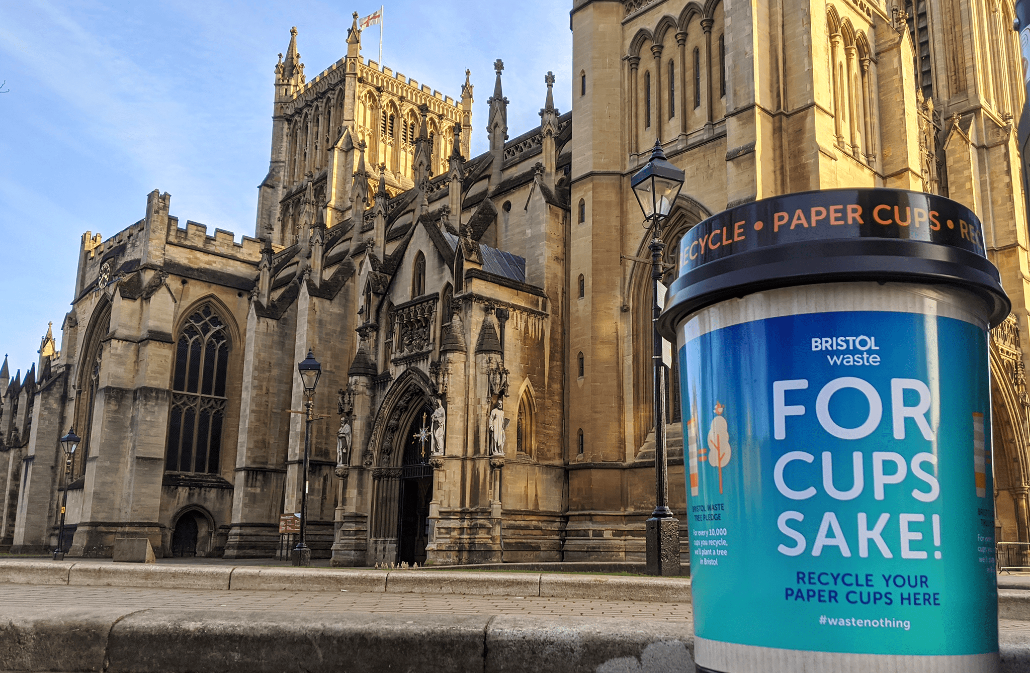 A Bristol Waste coffee cup bin in front of Bristol Cathedral