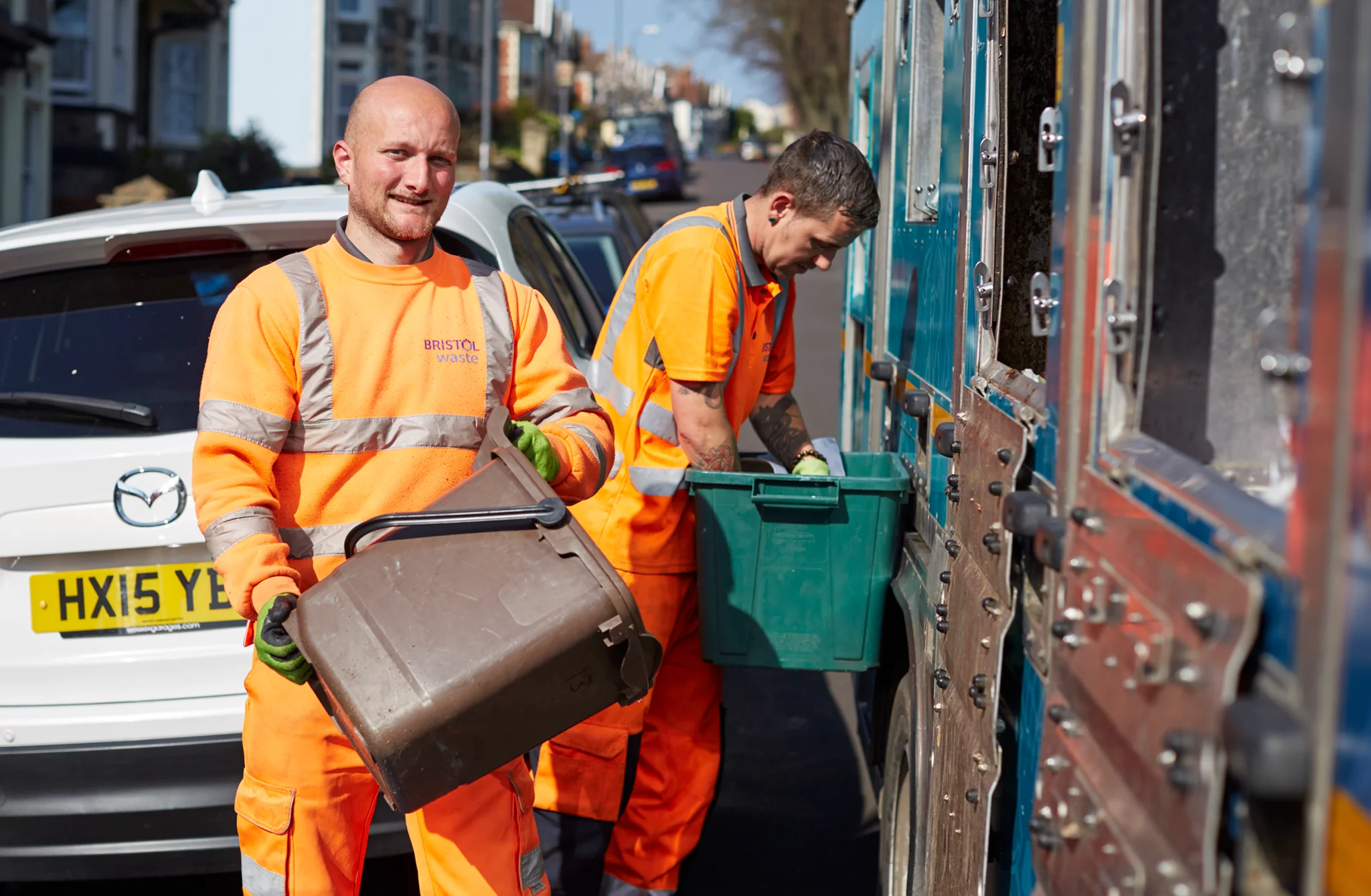 Bristol waste recycling crew unloading food waste into a recycling truck