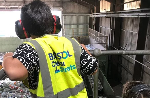 Child in high vis and ear protection on a tour of the transfer station talk