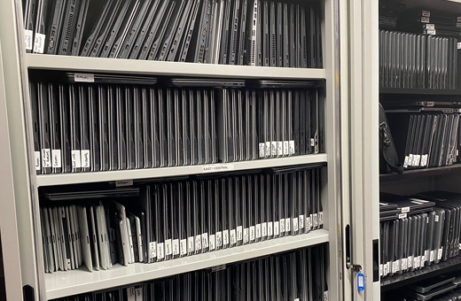 A shelf full of hundreds of laptops that will be used in the Digital Inclusion Scheme