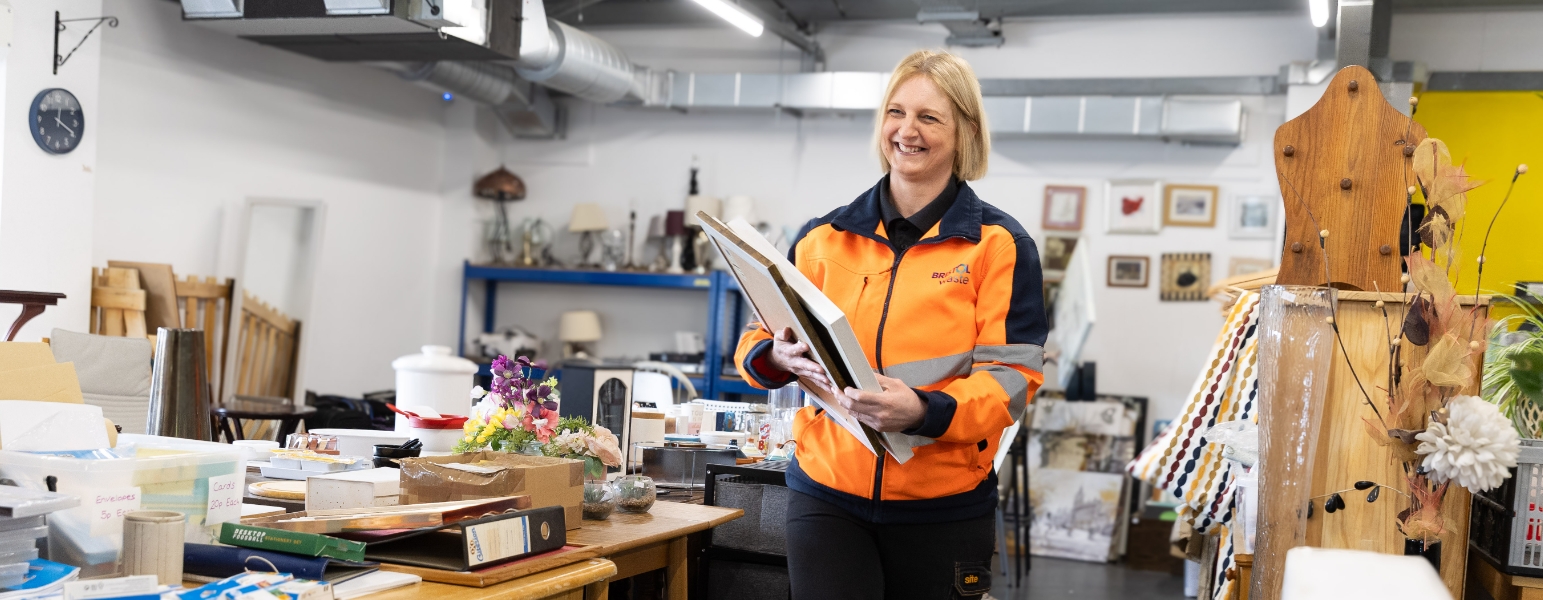 Woman in high visibility clothing walking through Reuse Shop