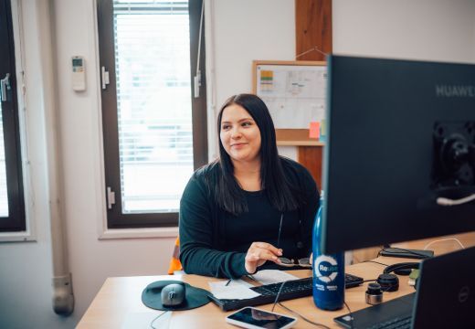 Woman sat at desk talking