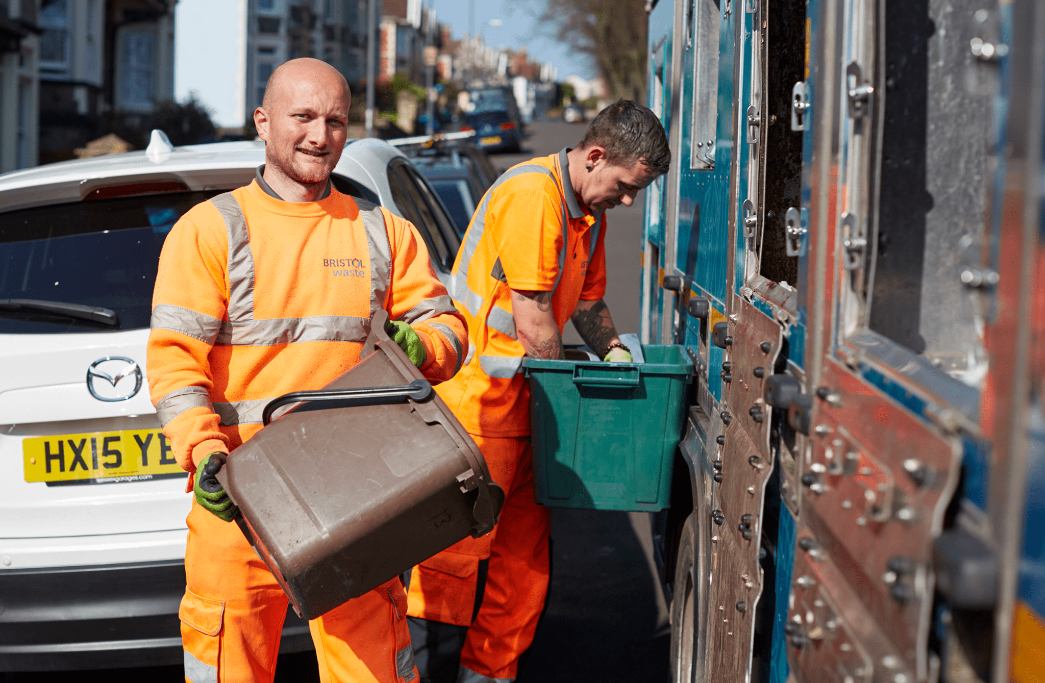 Bristol waste recycling crew unloading food waste into a recycling truck