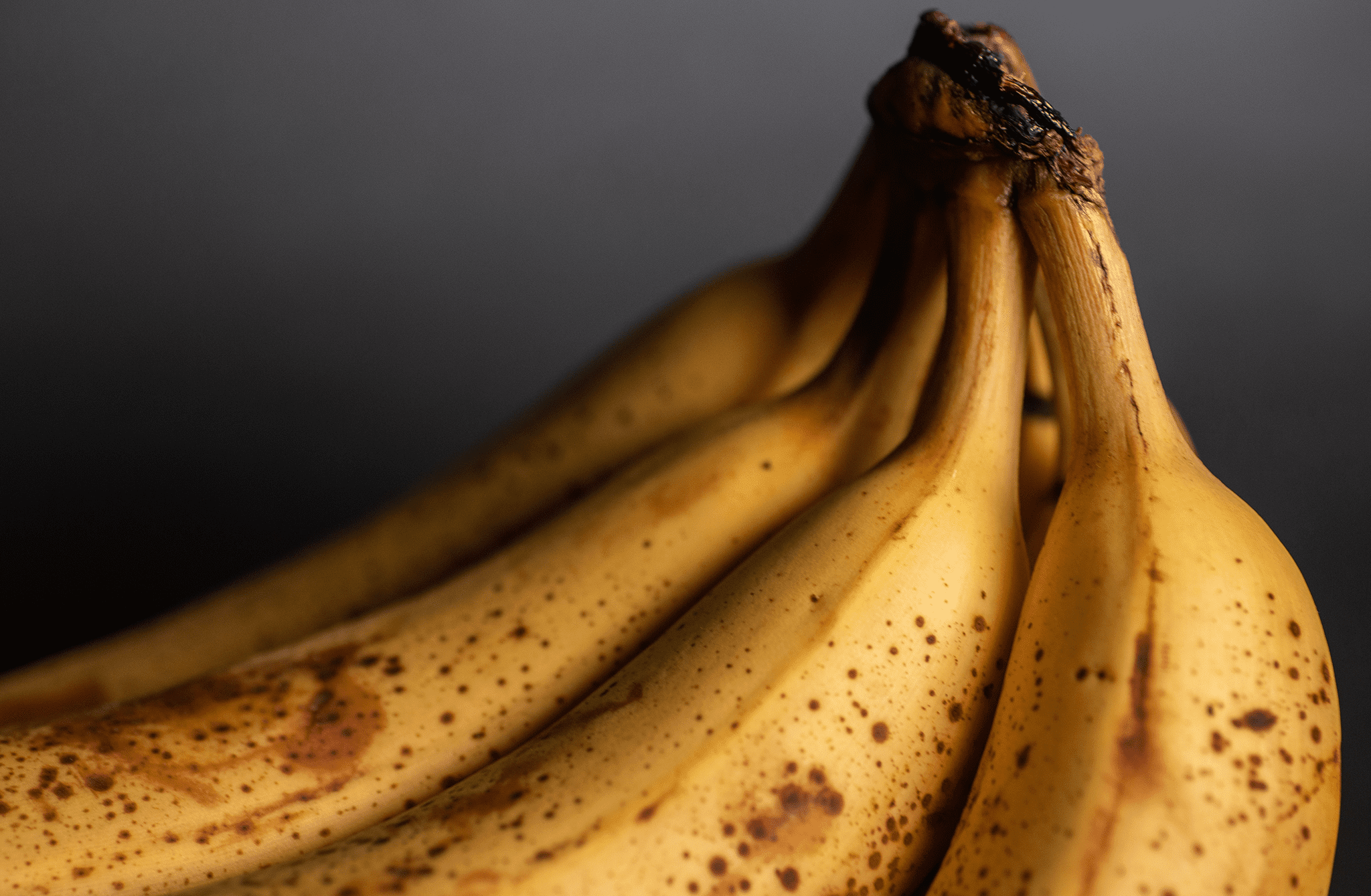 A bunch of bananas on a black background
