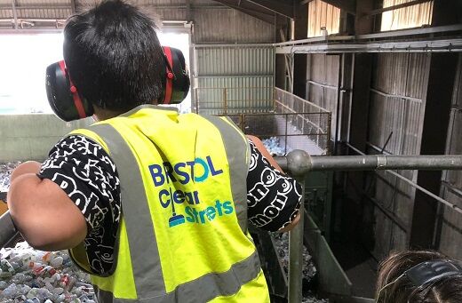 Child in high vis and ear protection on a tour of the transfer station talk