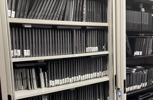 A shelf full of hundreds of laptops that will be used in the Digital Inclusion Scheme
