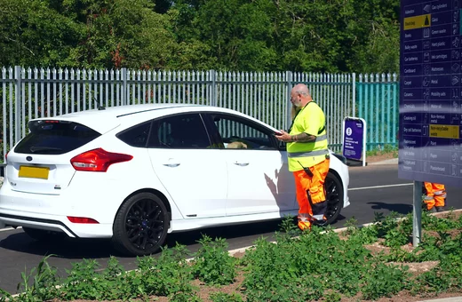 A Bristol Waste crew member checking ID of a driver entering the recycling centre