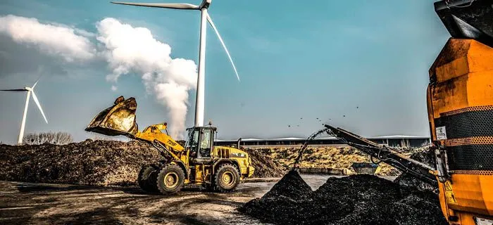 Two tractors shredding organic waste