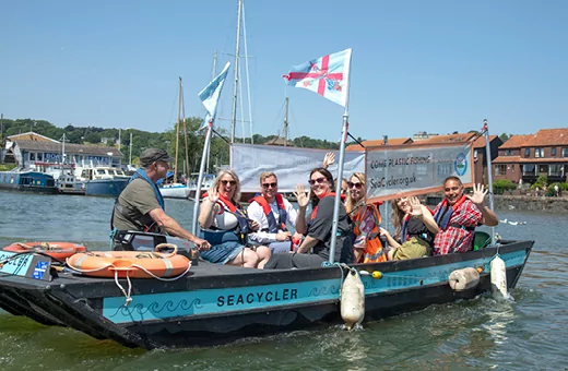 People sailing out on the Sea-Cycler to pick litter out of the harbour water