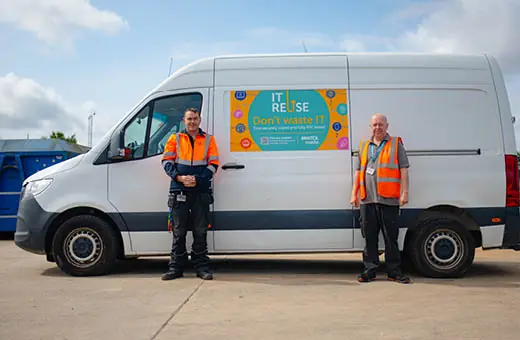 Two IT reuse crews standing next to their big white collection van
