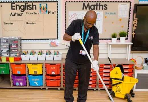 Man cleaning in school room