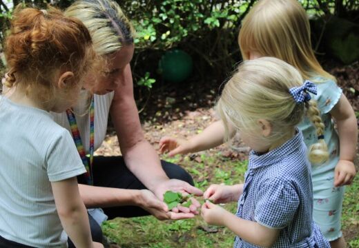 Woman with young children in garden