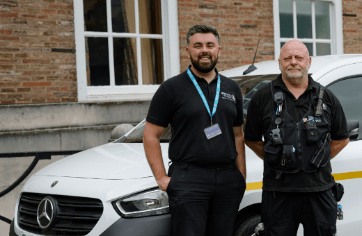 Two men standing in front of a van