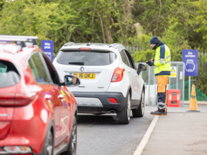 A Bristol Waste team member checks in visitors to the recycling centre
