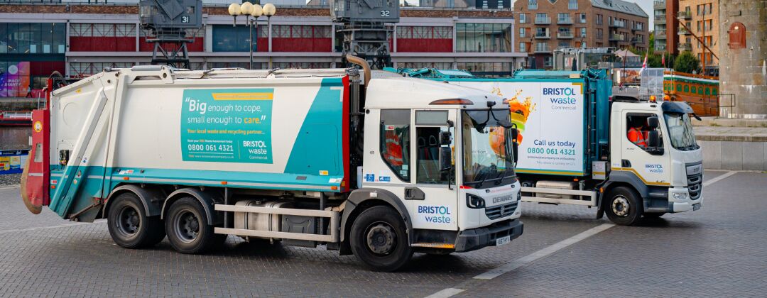 Two recycling trucks with a Bristol Waste logo