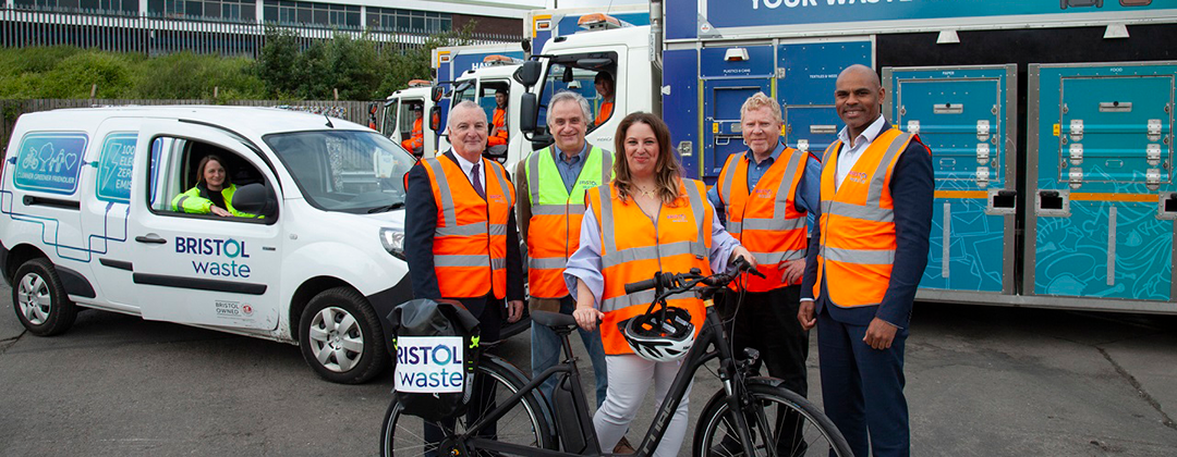 Bristol Waste and Bristol Council representatives standing in front of a recycling truck and electric van