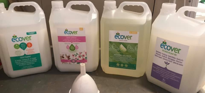 Photo showing cleaning refill liquids and funnel