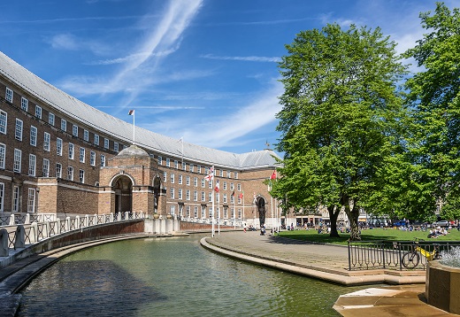 Image of Bristol City Council City Hall office and College Green with water and trees on the right hand side
