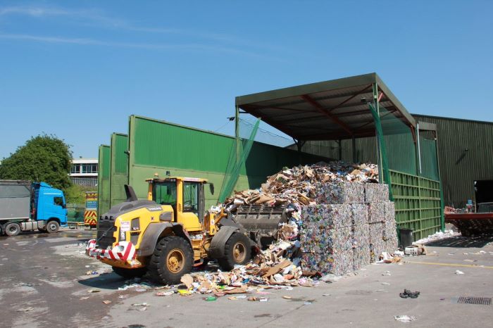 Tractor loading cardboard recycling at transfer station