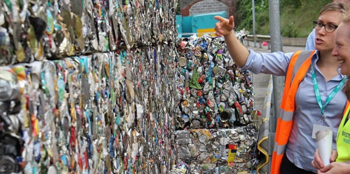 Bristol Waste staff showing recycling bales to a visitor