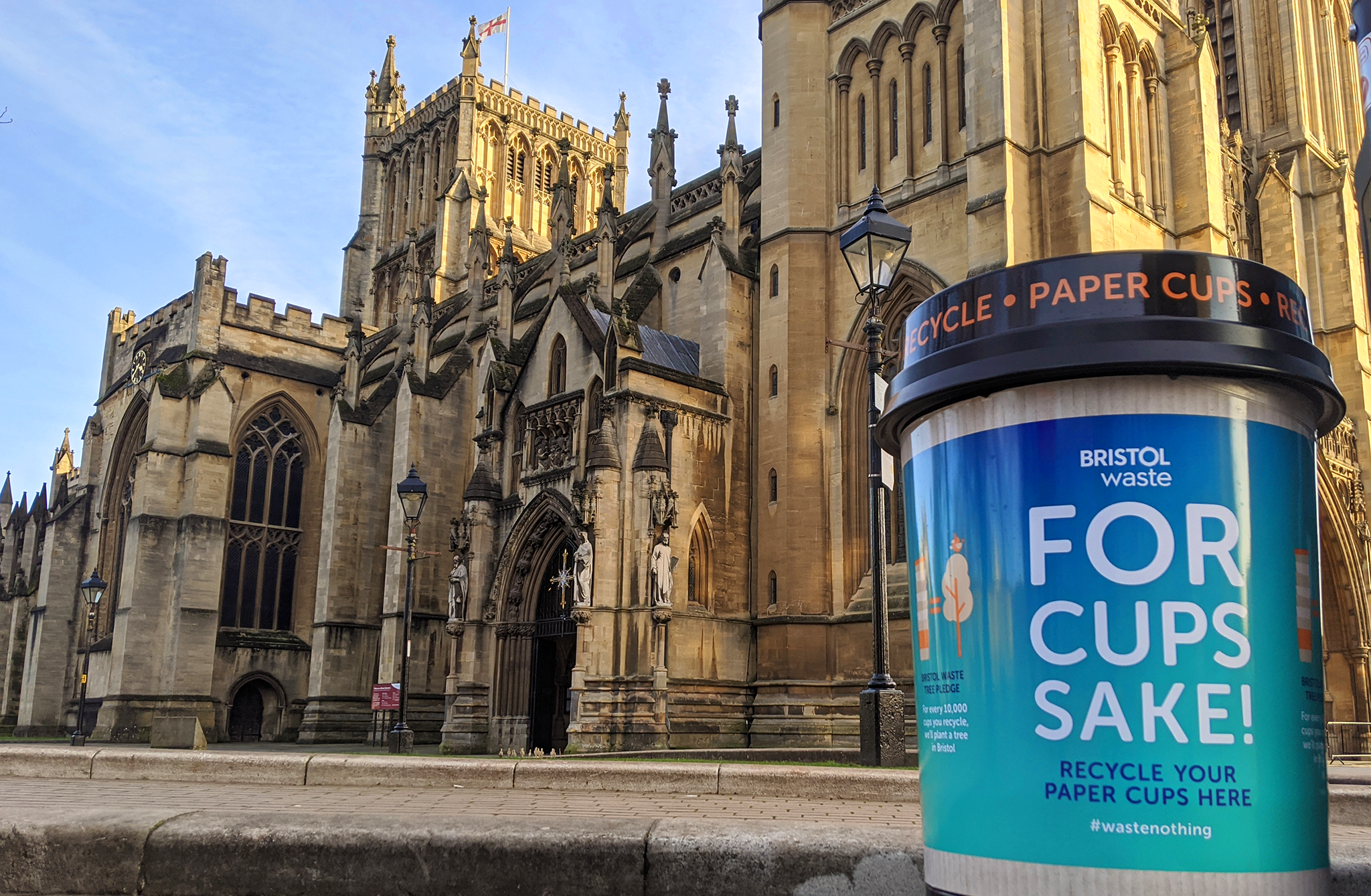 A Bristol Waste coffee cup bin in front of Bristol Cathedral
