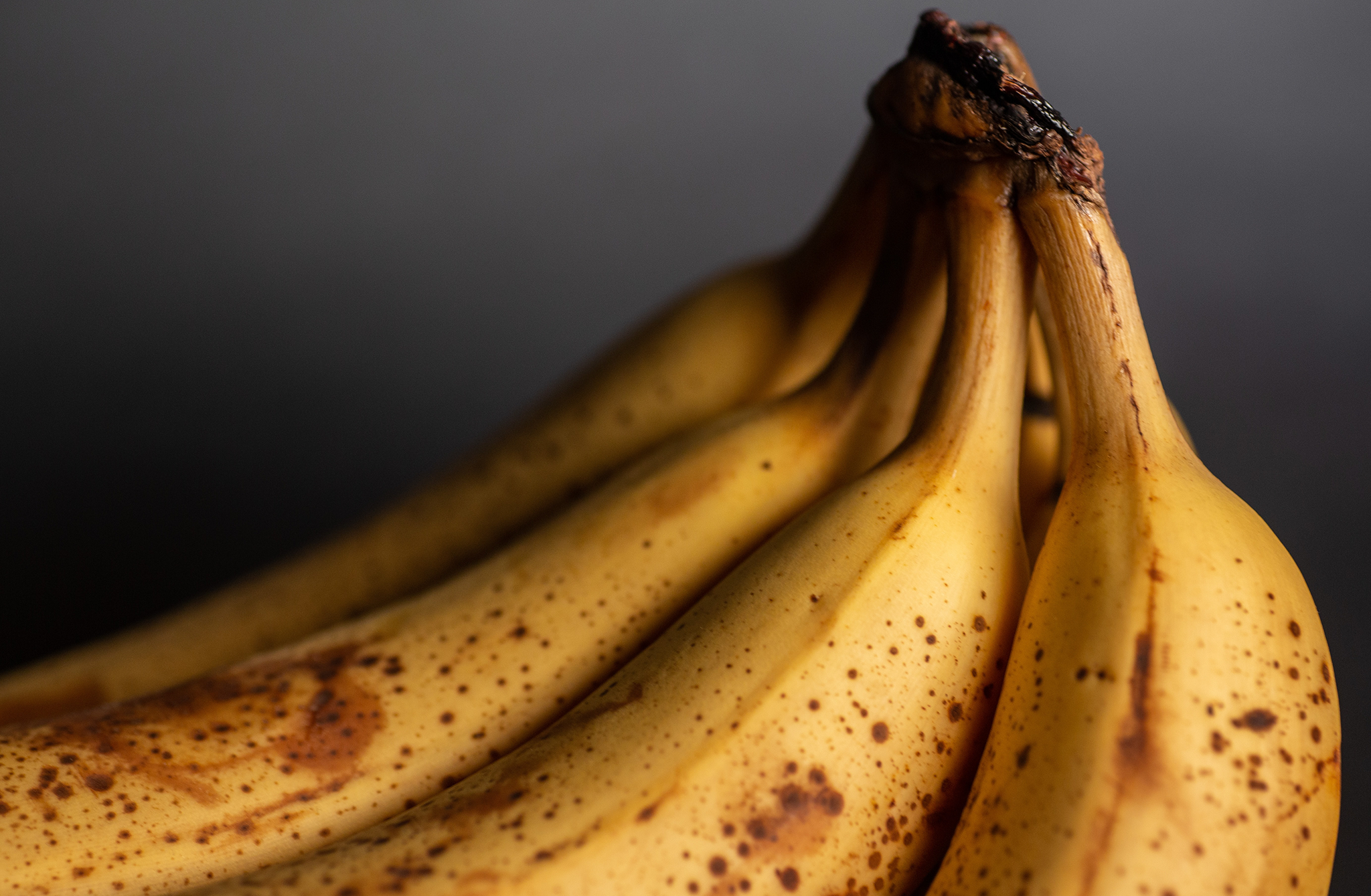 A bunch of bananas on a black background