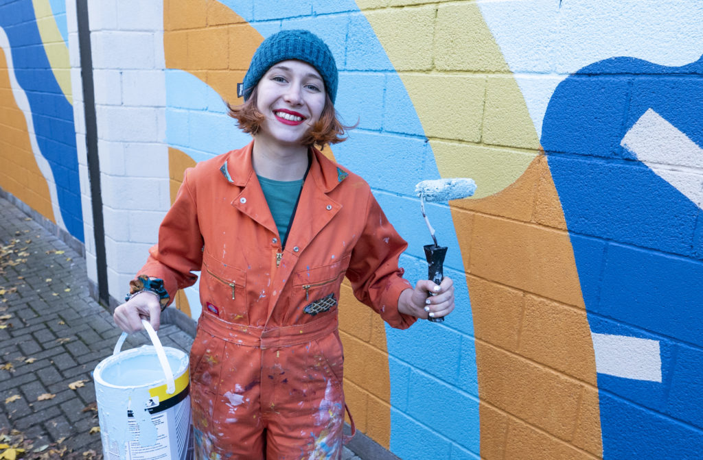 Artist Jenny Simmons with a bucket of paint and a roller during Easton leisure centre's big tidy.