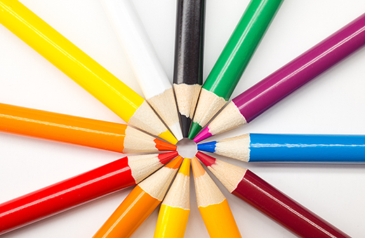 A circle of colourful pencils with the tips pointing in towards each other