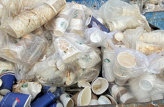 A bag full of recyclable coffee cups of all shapes and sizes