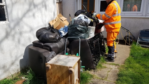 Bristol Waste employee clears fly-tipped waste and recycling