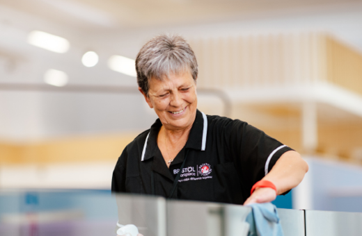 A smiling women office cleaning and providing facility management