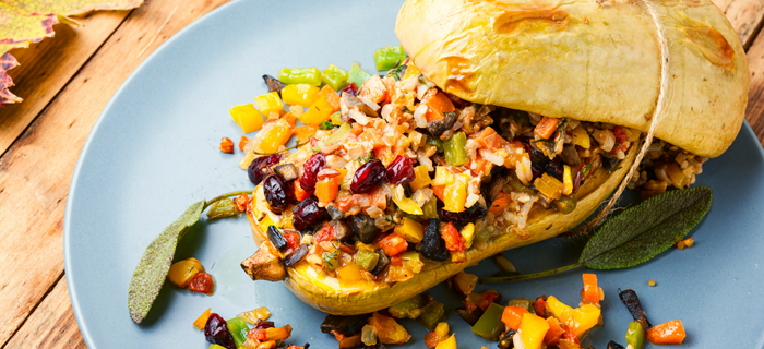 A roasted butternut squash halved and filled with pumpkin stuffing