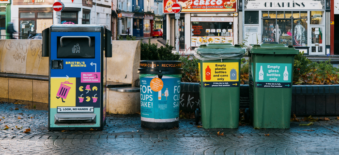 A row of colourful bins decorated with Bristol's binning signage