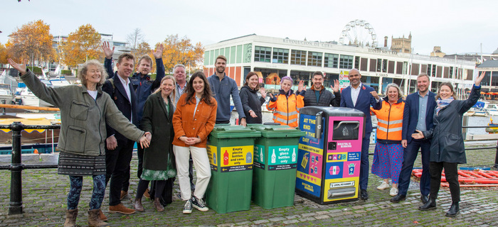 A group of people pose around new Bristol litter bins on the harbourside