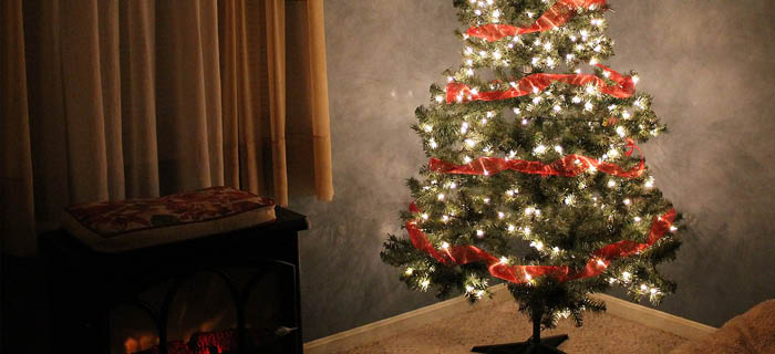 A plastic Christmas tree glowing in a room