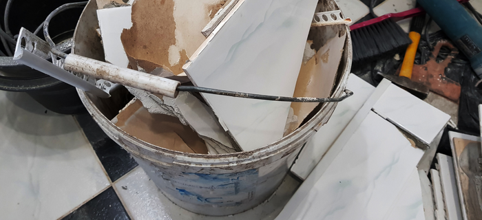 A bucket of broken plasterboard and other DIY waste