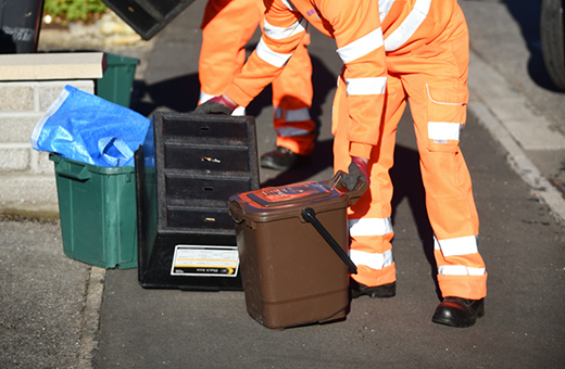 Refuse collectors picking up recycling bins